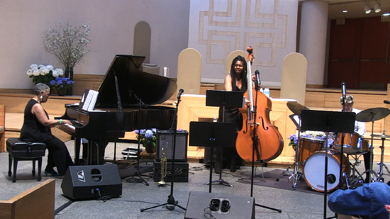 Three woman playing instruments in a jazz band.